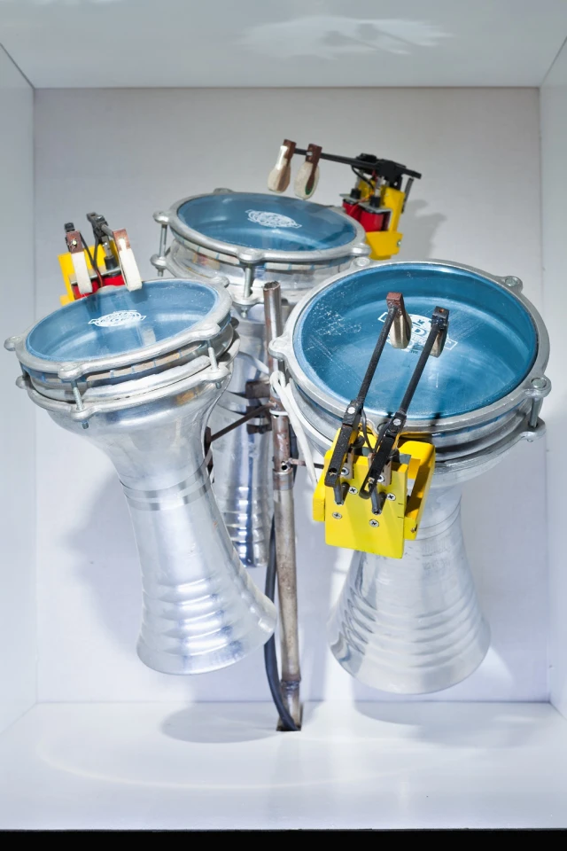Motor and solenoid actuators triggered by power electronics and an Arduino microcontroller pound the beats to music written with Ableton Live