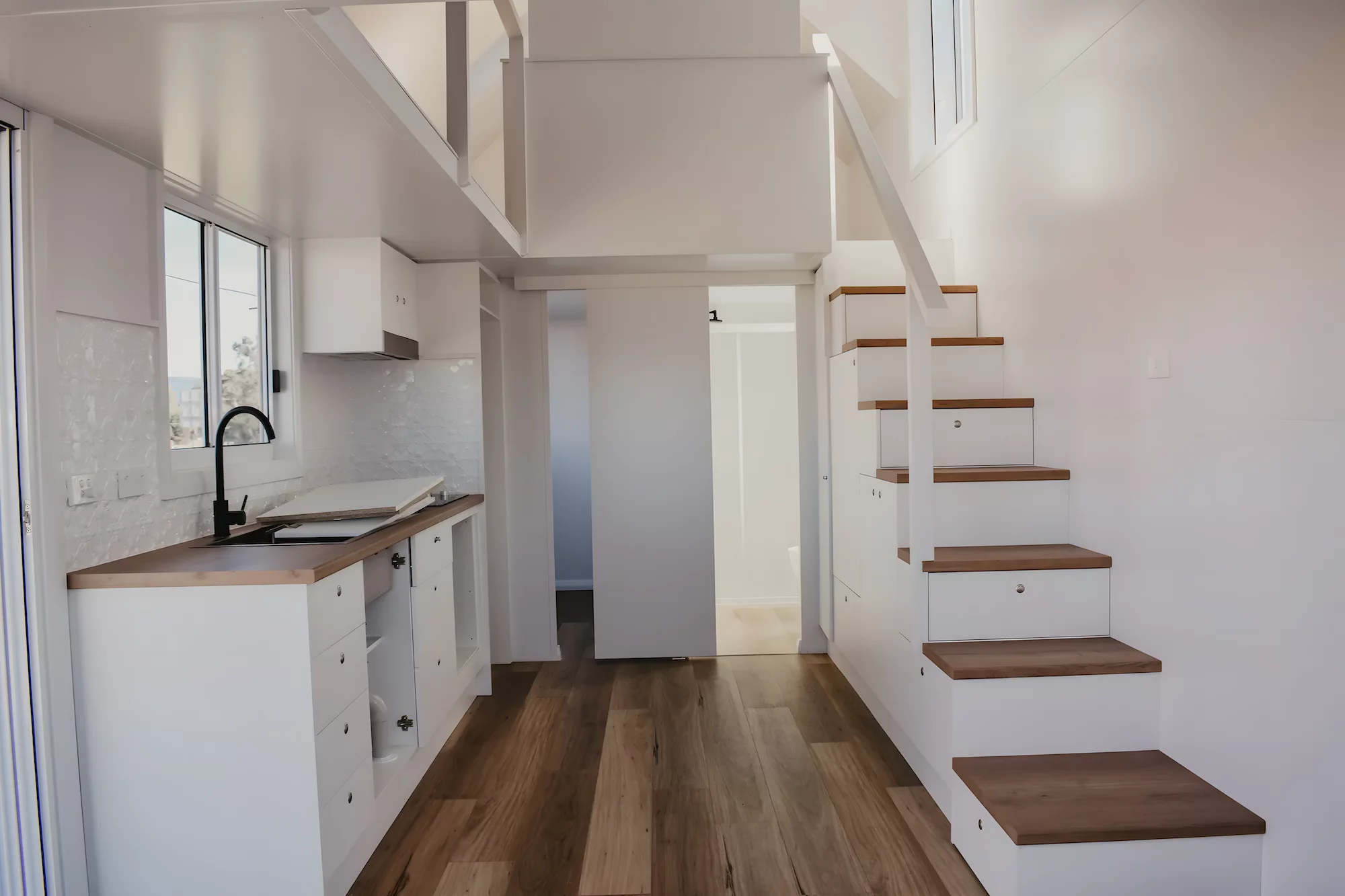 The Joely's upstairs bedrooms are reached by a storage-integrated staircase