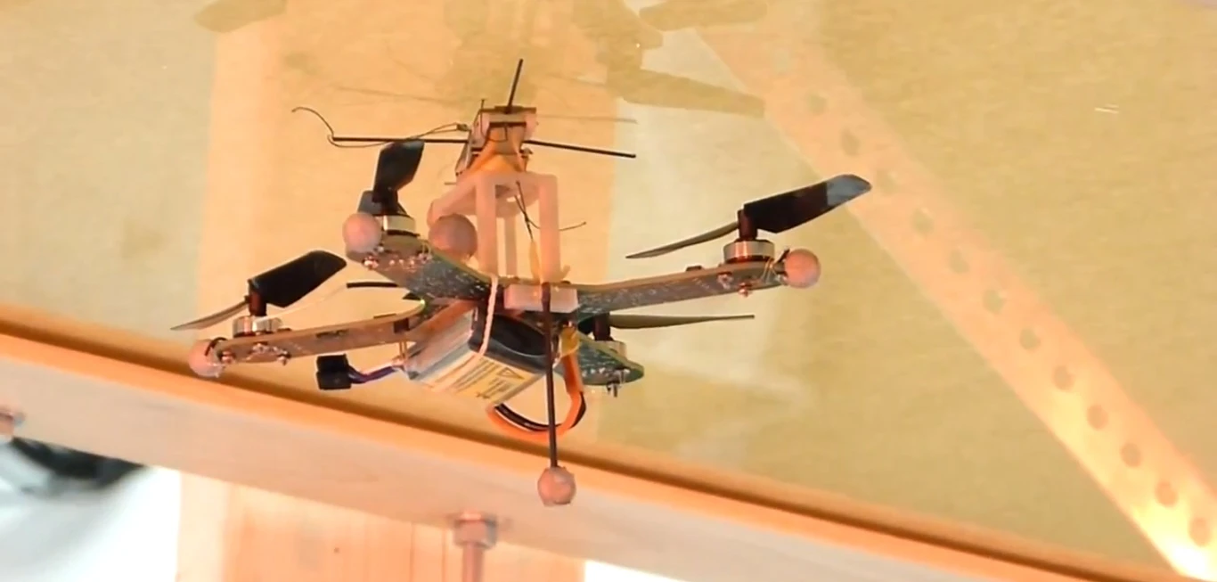 Researchers have developed a quadcopter that can attach to walls and ceilings with a dry adhesive before taking off again