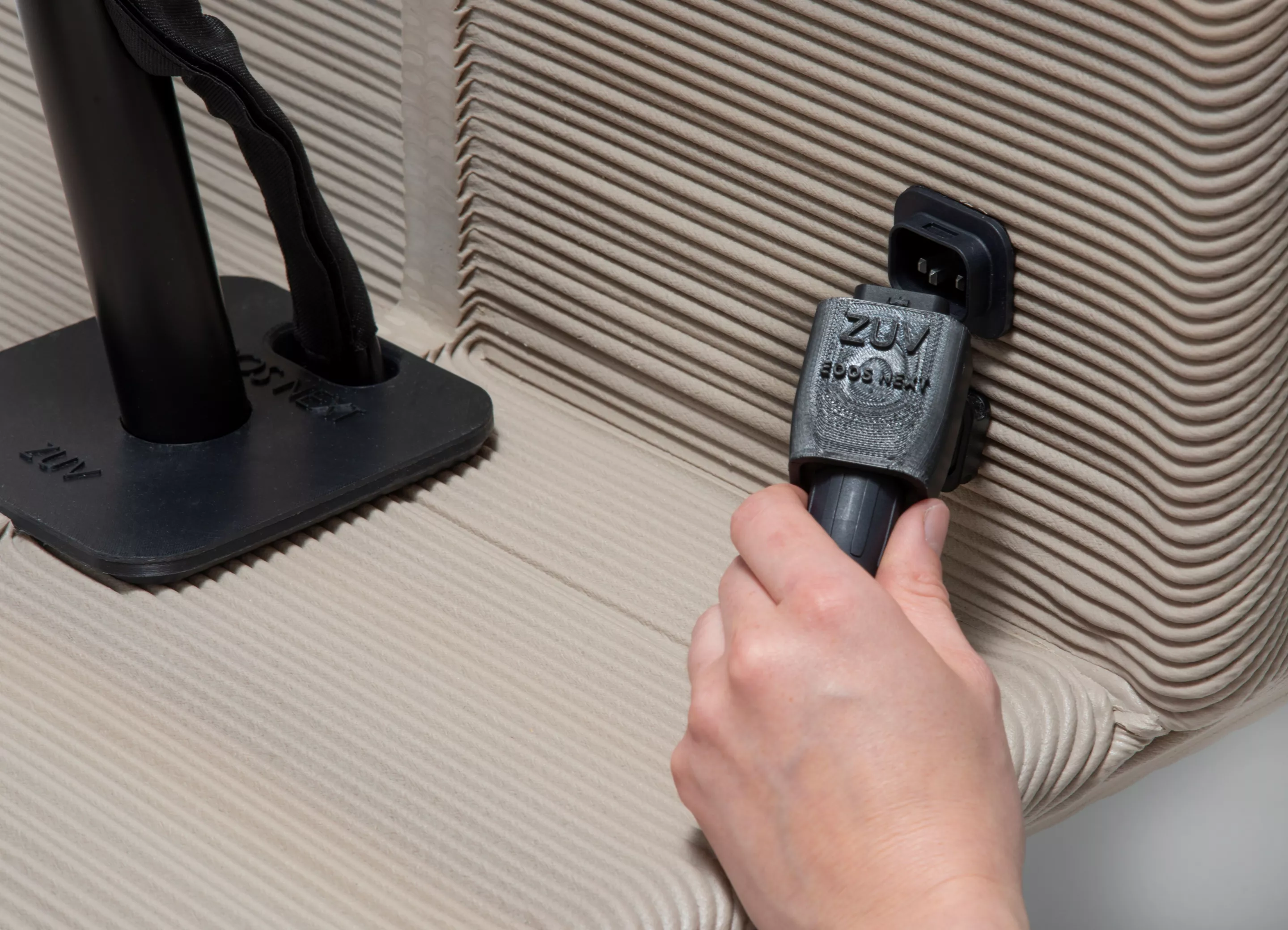 The charging port is located in the footwell, on the side of the cargo box