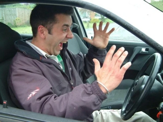 This man appears to be annoyed by interior buzzing sounds in his car. We suggest he gets a Rattlebuster post-haste.