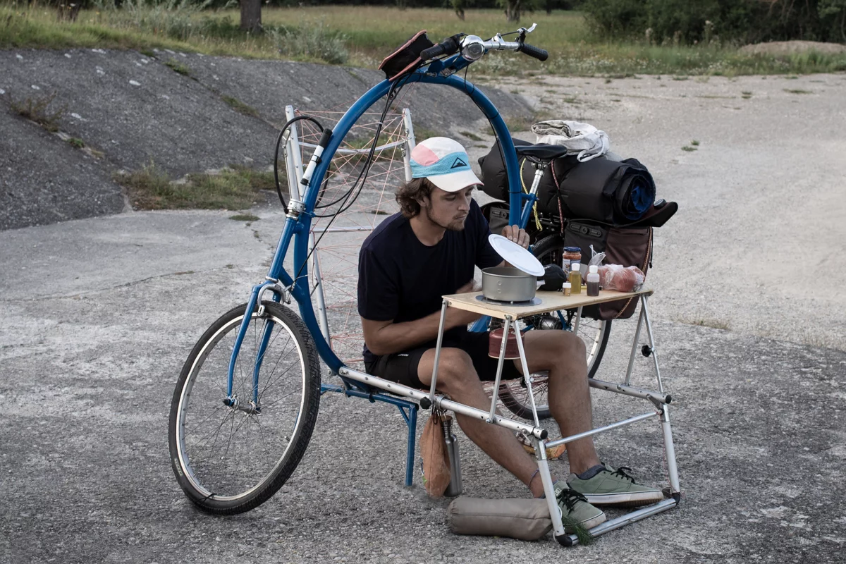 Inventor Bernhard Sobotta stops to chow down during a Cercle bike ride – the chair/table module folds back flat to become a cot