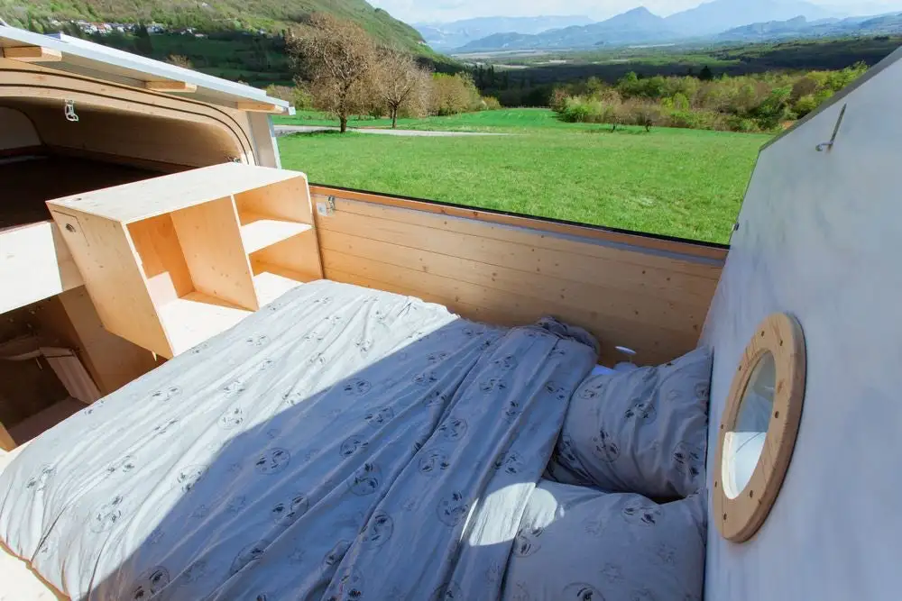 La Tête dans les étoiles' loft bedroom, shown with the roof in the open position