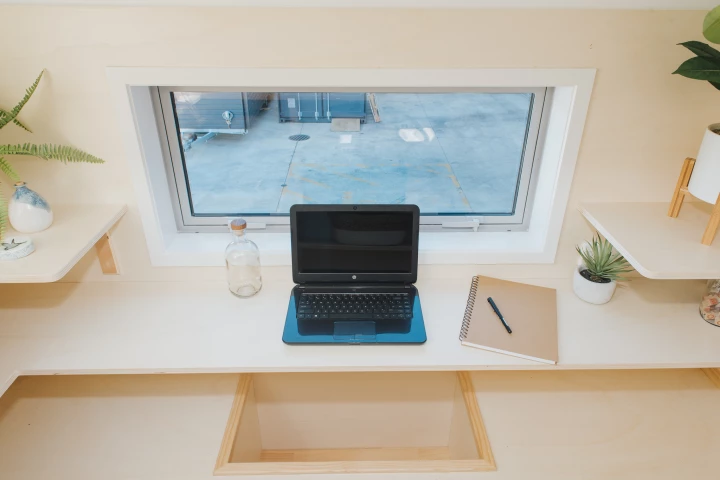 The Wai-Iti Tiny House's office area has a small space for people to lower their feet, making sitting more comfortable