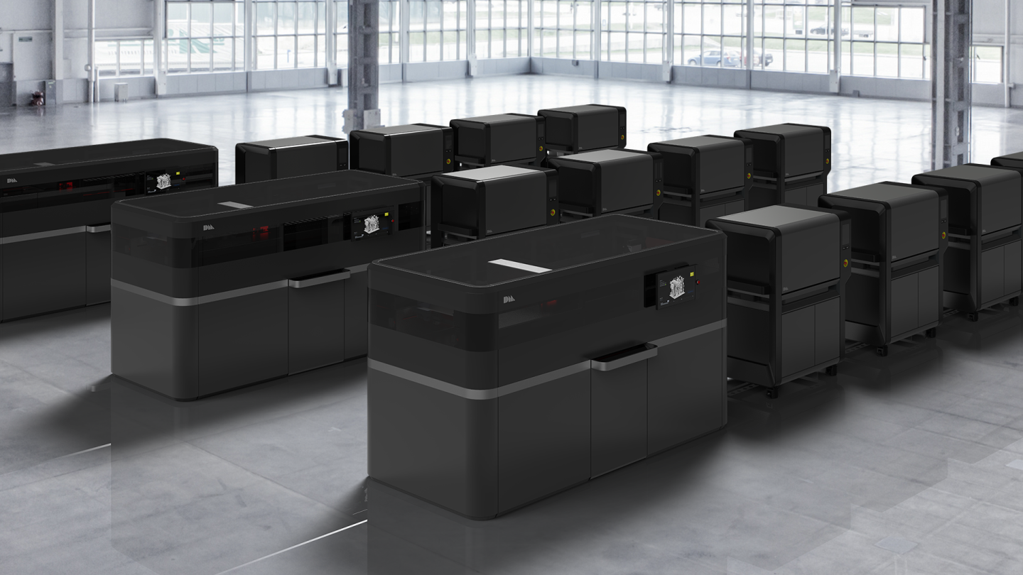 Desktop Metal production system. Each printer (left) runs so fast it needs up to four hybrid furnaces for sintering