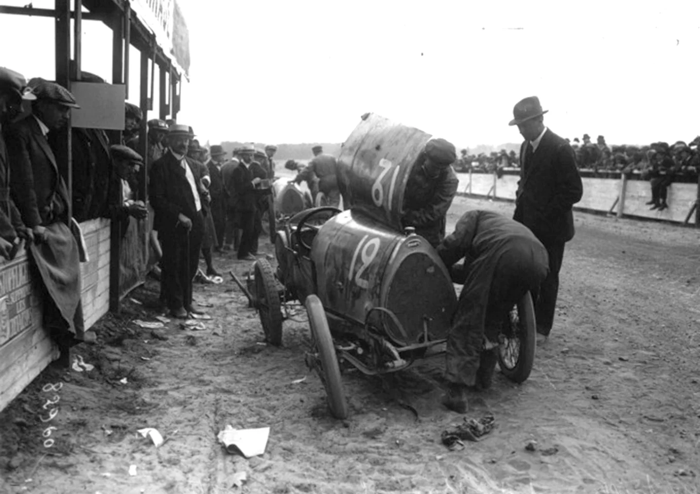 Michele Baccoli's Bugatti T13 takes a pit stop during the "VIII Coupe des Voiturettes" held on 29 August, 1920 at the Circuit de la Sarthe Circuit (Le Mans). Baccoli finished fifth. Note that only the driver and the riding mechanic were allowed to work on the car, and the trusting official watching on is standing ion the racetrack. Roads were largely unpaved, as were racetracks.