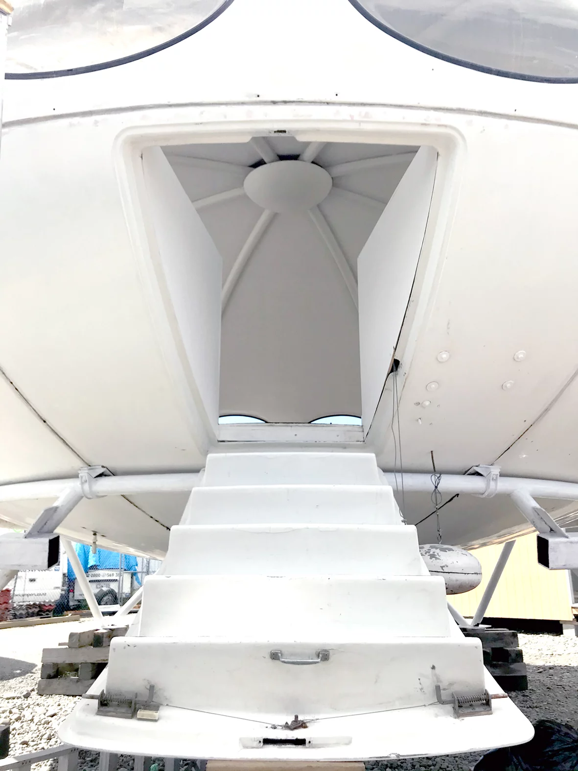 The Futuro house is accessed by a hatch-style door and ladder