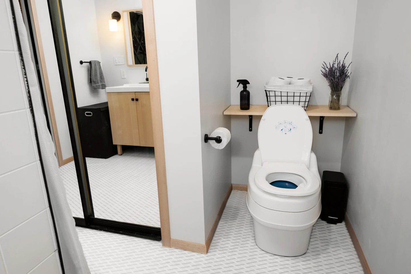 The bathroom features a composting toilet
