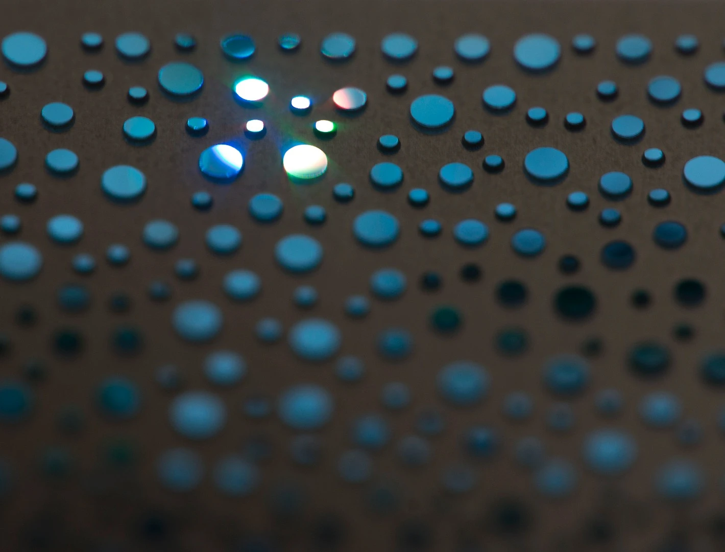 The light of the CubeSensors shines through a pattern of holes cut into the metal front and rear