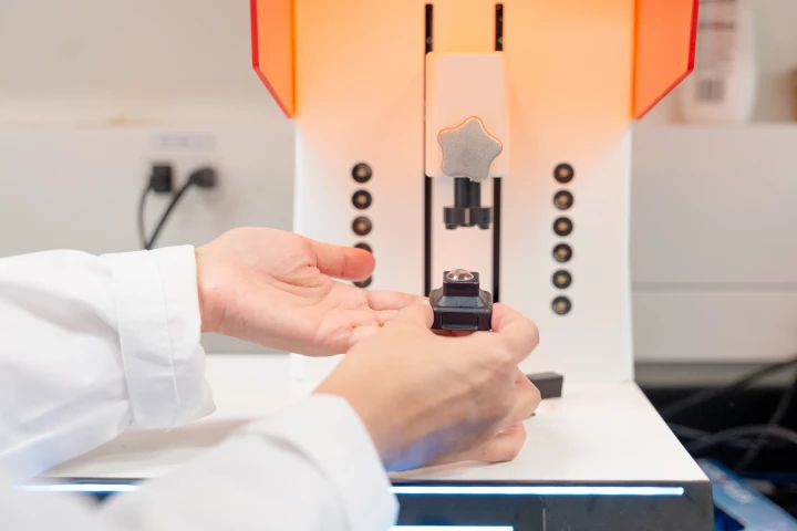 One of the custom 3D-printed contact lenses on the printing platform at the University of Waterloo’s Tang Nanotechnology Lab