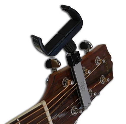 The headmount clips over the strings of the guitar's headstock so that the device is always within easy reach