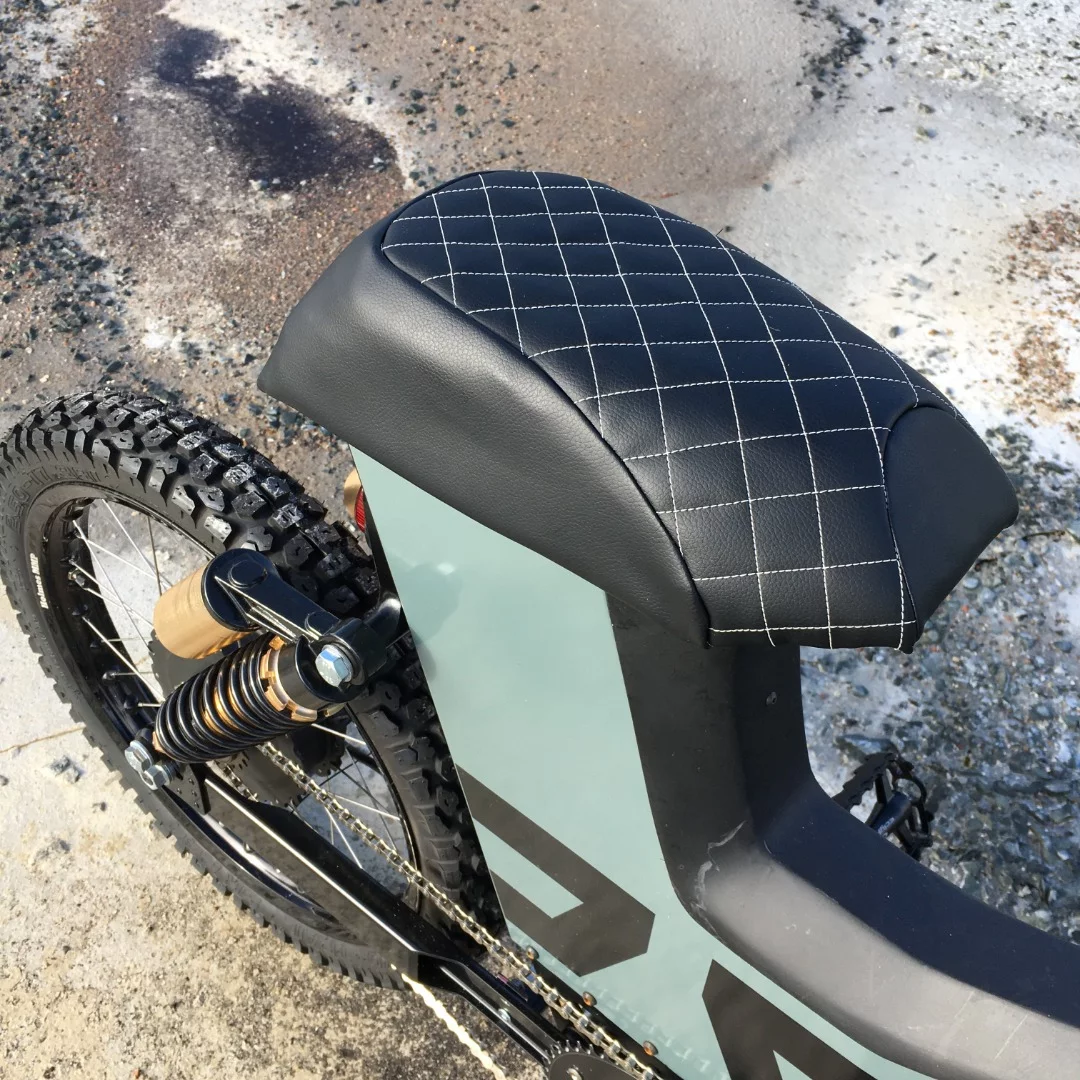 The Suru Scrambler benefits from a pleated seat and gold anodized reservoir shocks