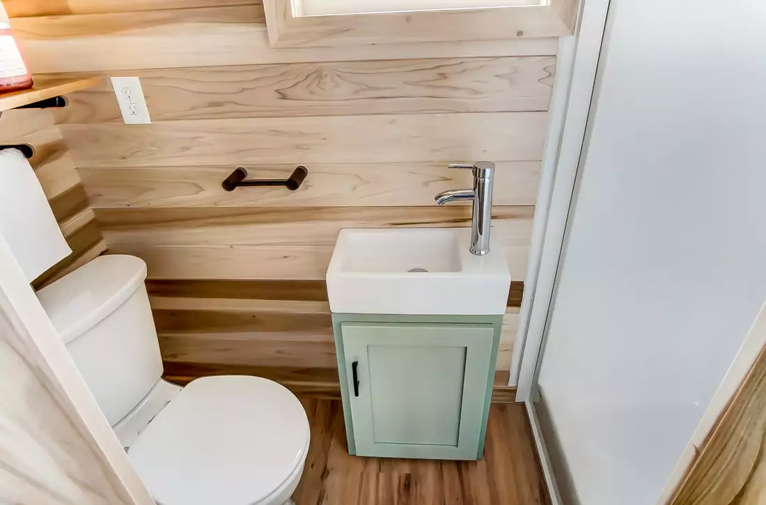 The Clover's bathroom includes toilet, sink, and shower