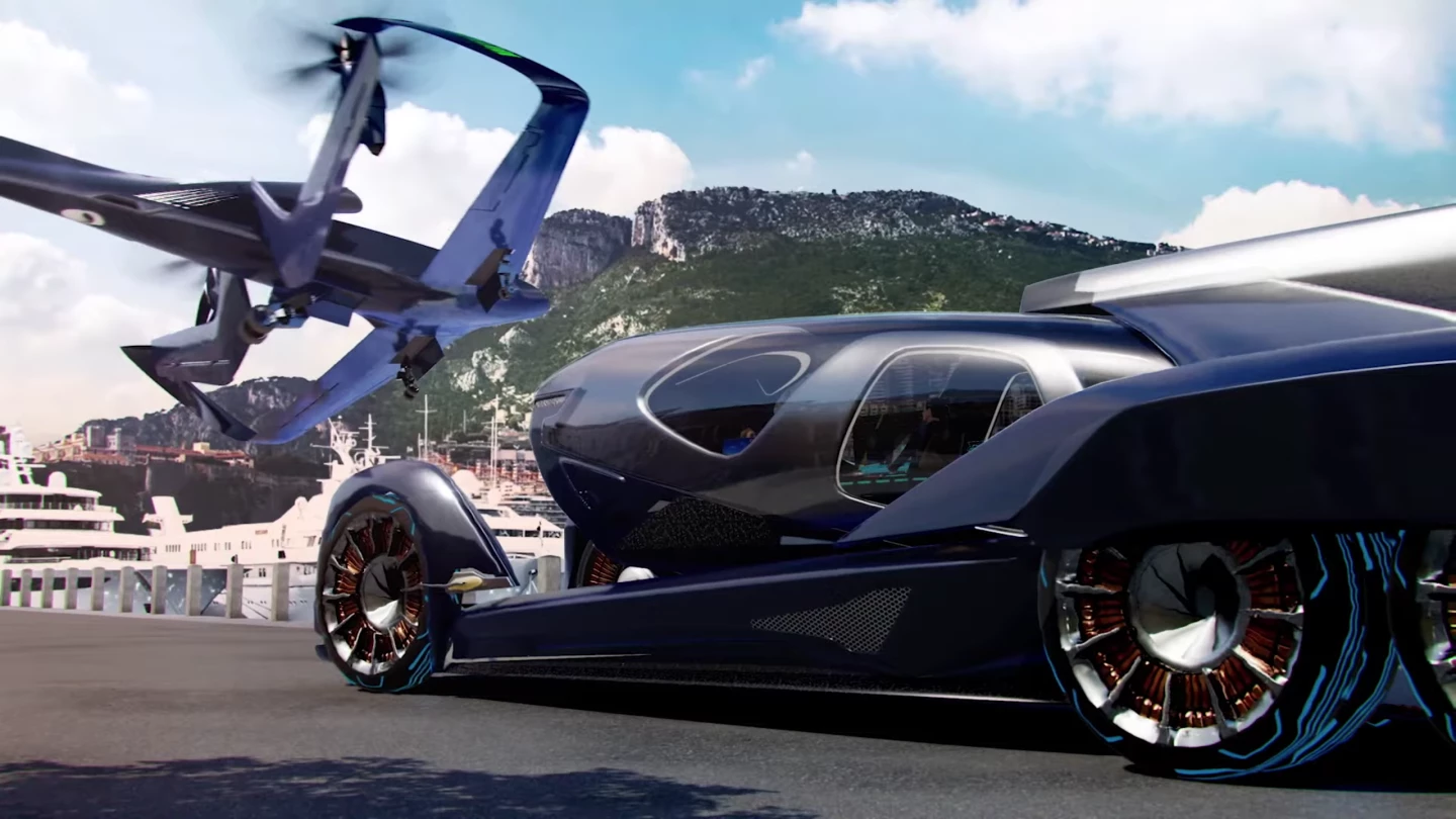 The airframe drops the passenger pod off onto a self-driving electric car chassis for relatively seamless last-mile transport