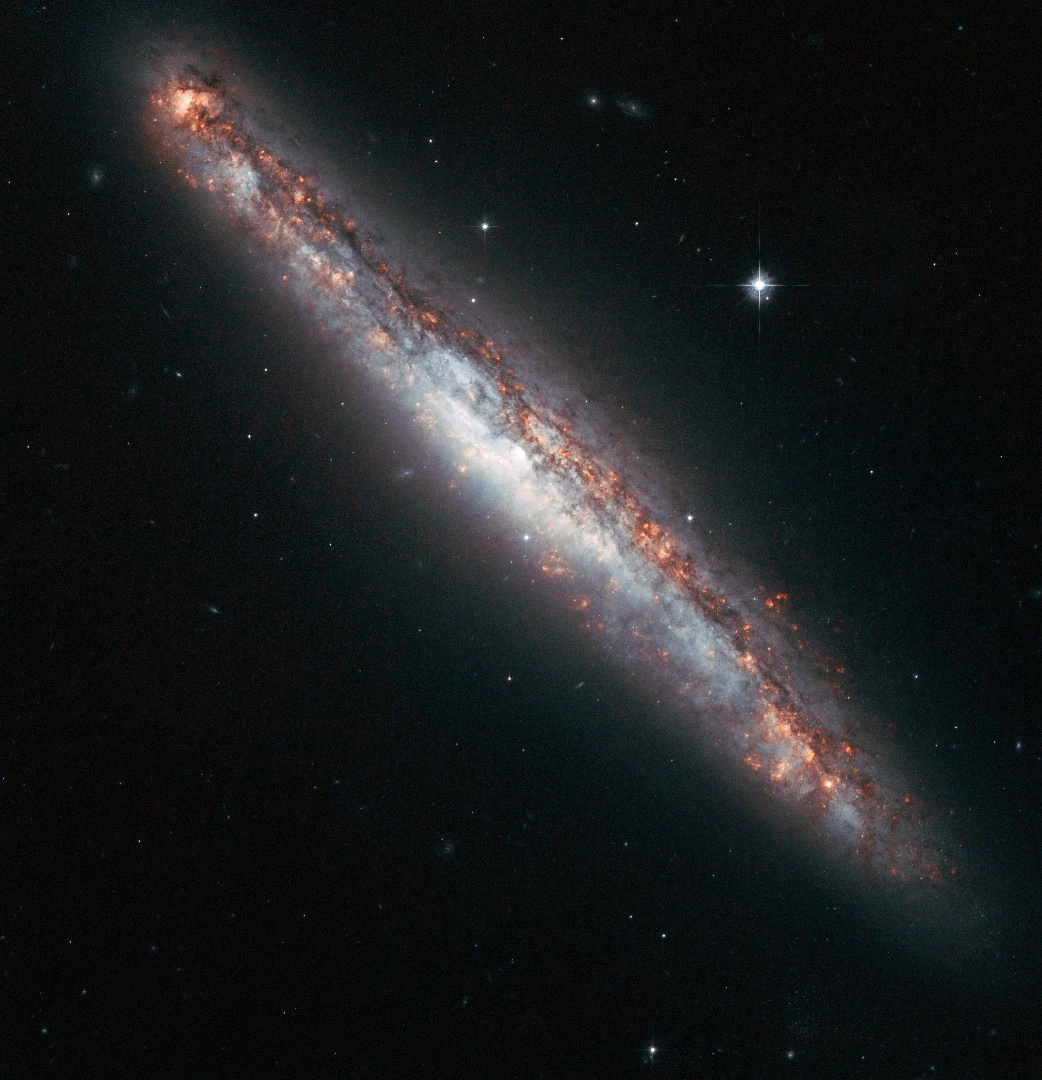 An edge-on profile of the slender spiral galaxy NGC 5775. Although the spiral is tilted away from us, with only a thin slither on view, such a perspective can be advantageous for astronomers because the regions above and below the galaxy’s disc can be seen much more clearly