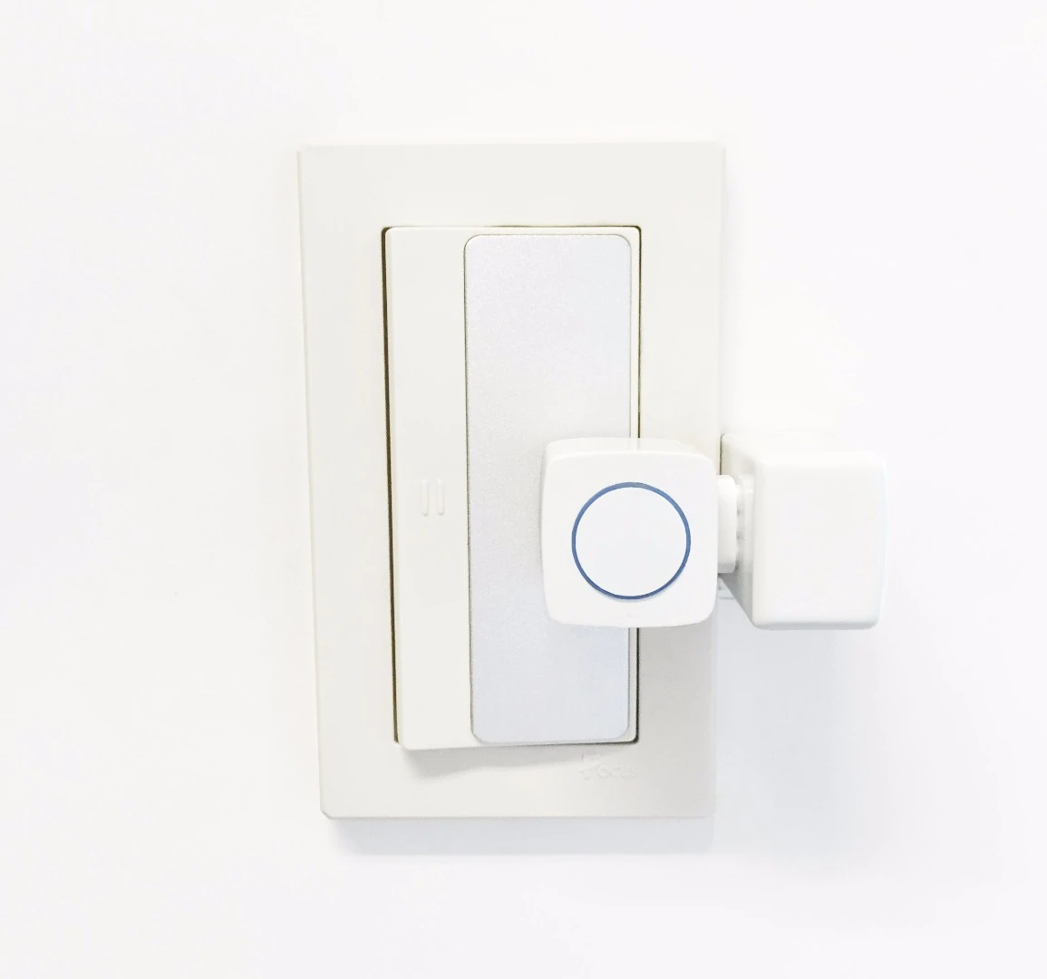 The Microbot Push attaches to surfaces using foamed tape