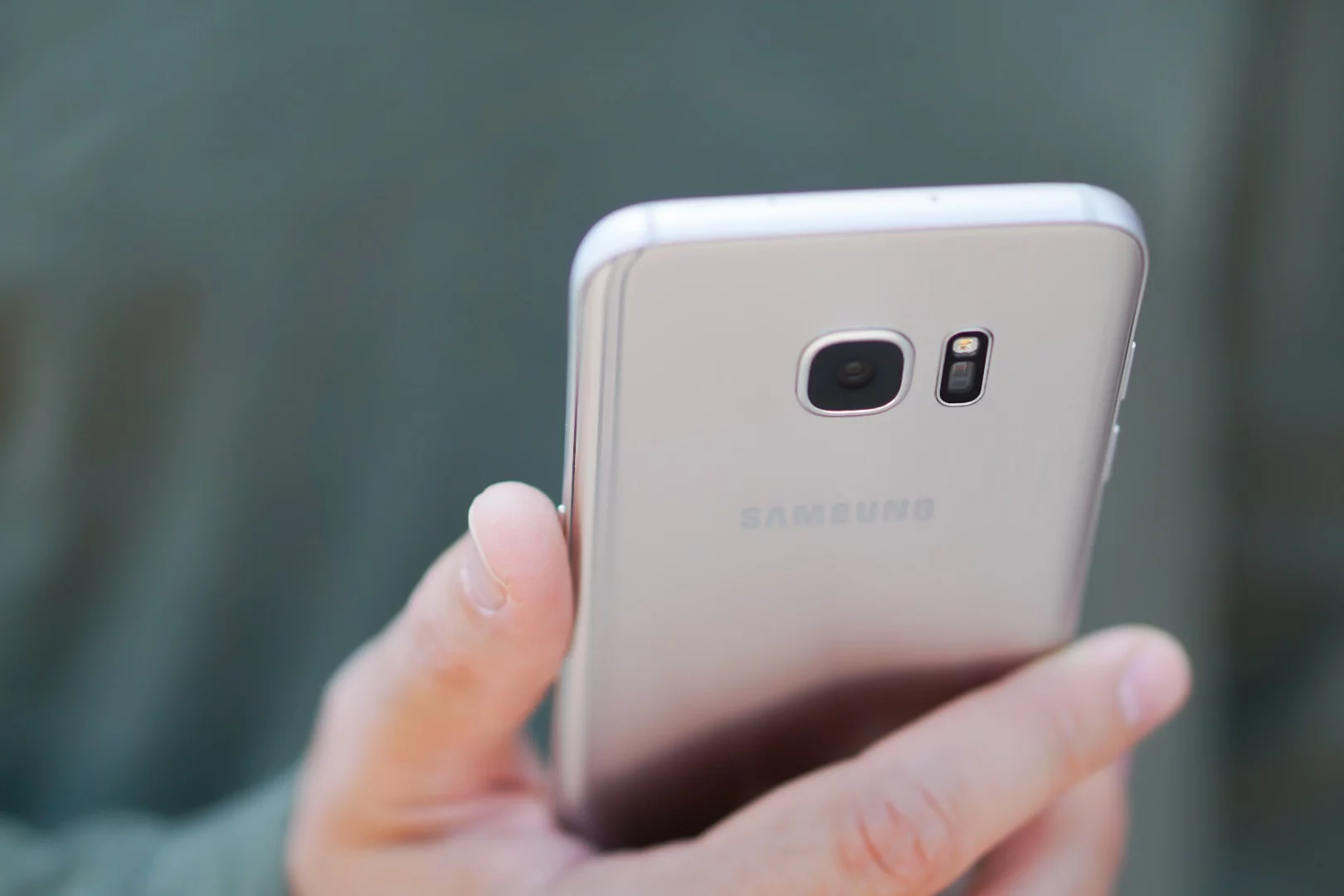 The silver Galaxy S7 edge in hand