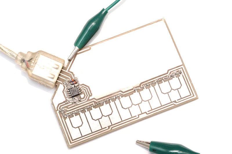 A hand-etched prototype StyloCard featured a 20 key Stylophone keyboard, an ATtiny85 chip, some resistors and a USB plug