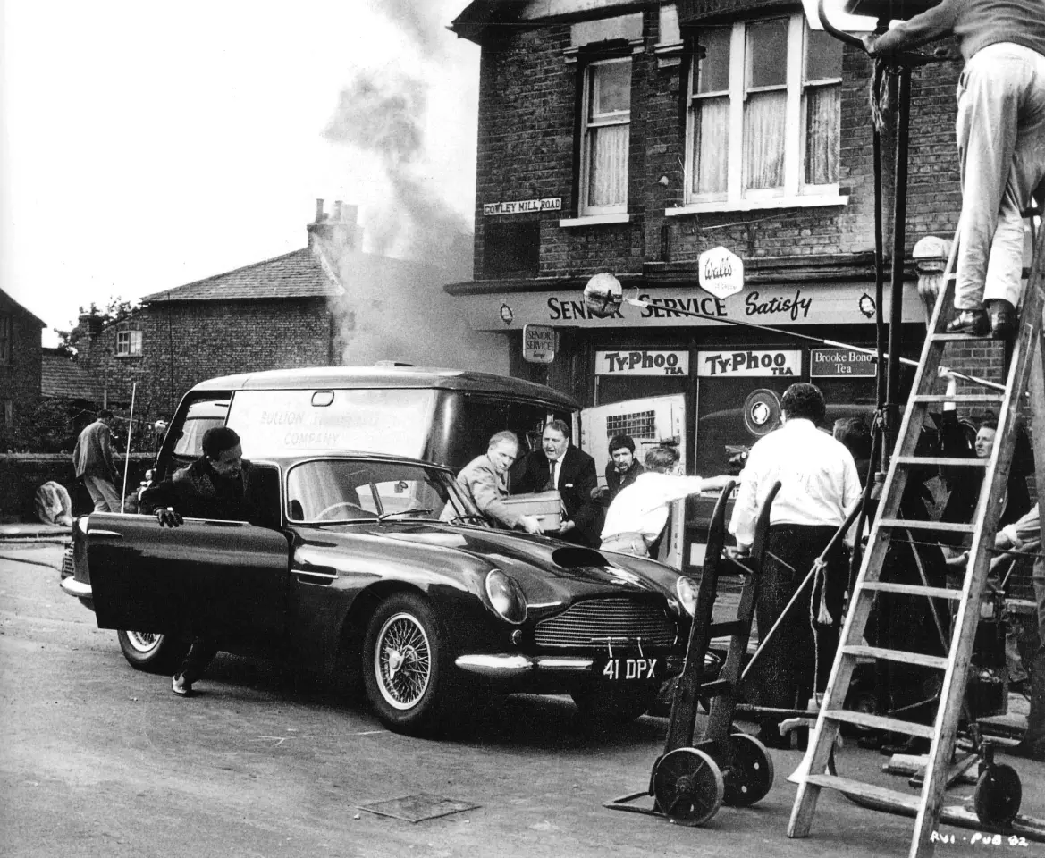 Peter Sellers at work on the movie "The Wrong Arm of the Law", with the Aston Martin DB4 GT front and center.