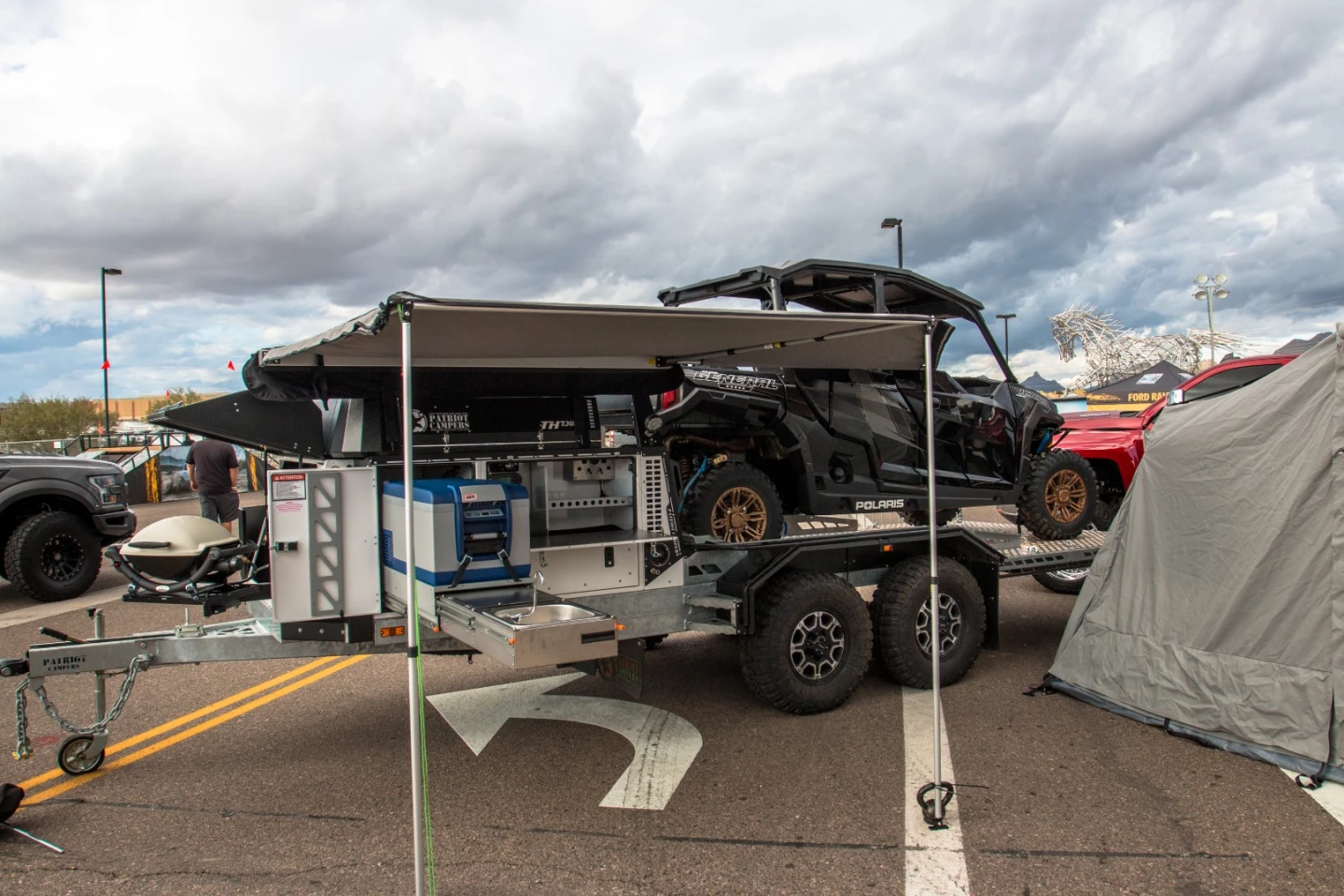 Patriot smashes together a boxy camper trailer and a toy-hauling cargo bed to create the TH730