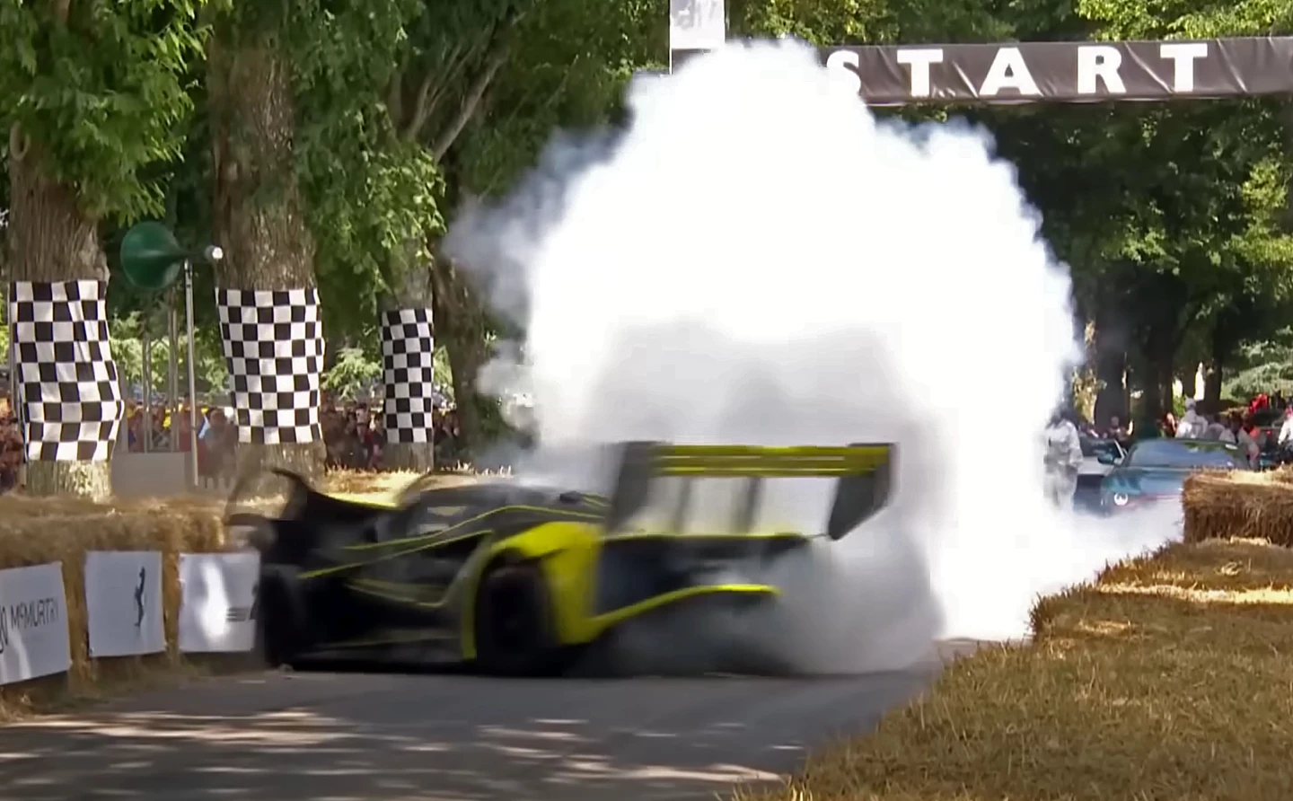 The Lotus Evija X crashes off the start, hitting the hay bales, tearing off its front clip, and nearly doing a full 360