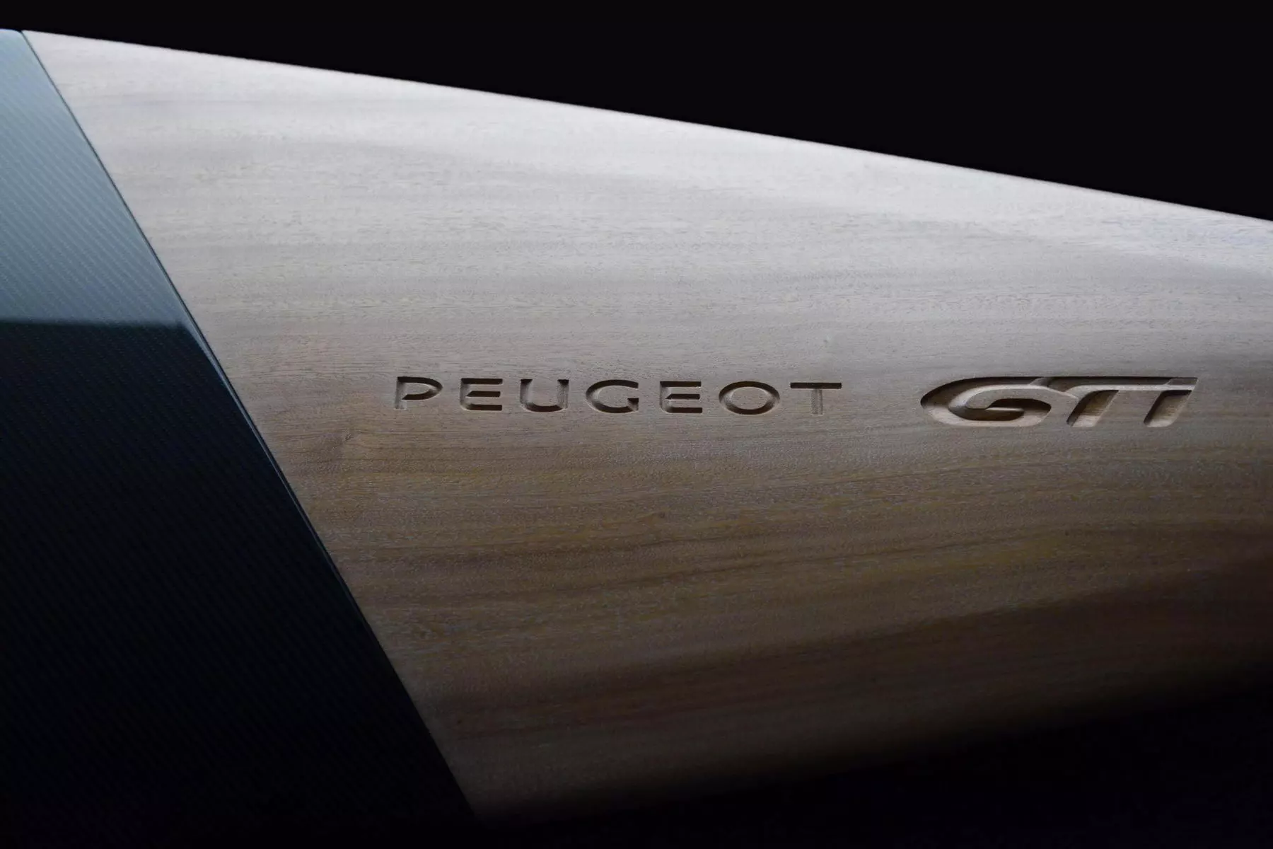 The Peugeot branding is engraved on the board's wooden nose