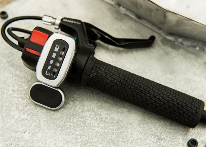 The handheld controller includes a thumb throttle and a brake lever