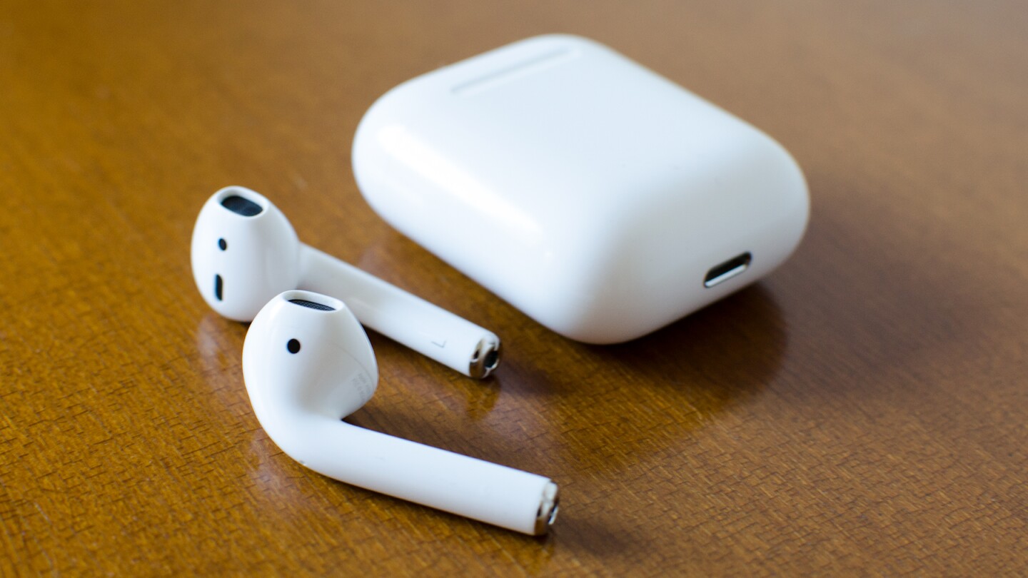 The AirPods and their storage/charging case, shown with the Lightning port on the bottom