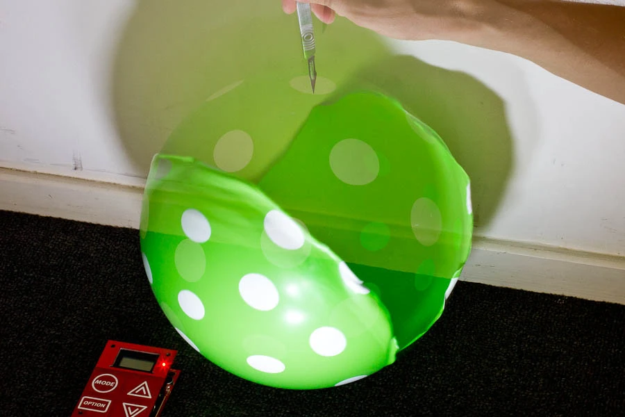 The Triggertrap is triggering a couple of Canon 580 EX II flashes when it registers the sound of the balloon's pop - first image