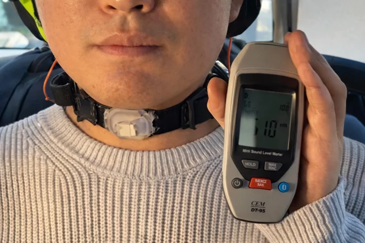 The neckband is made of soft silicone and combines a miniature camera and motion sensors with an AI model trained on the wearer's own voice