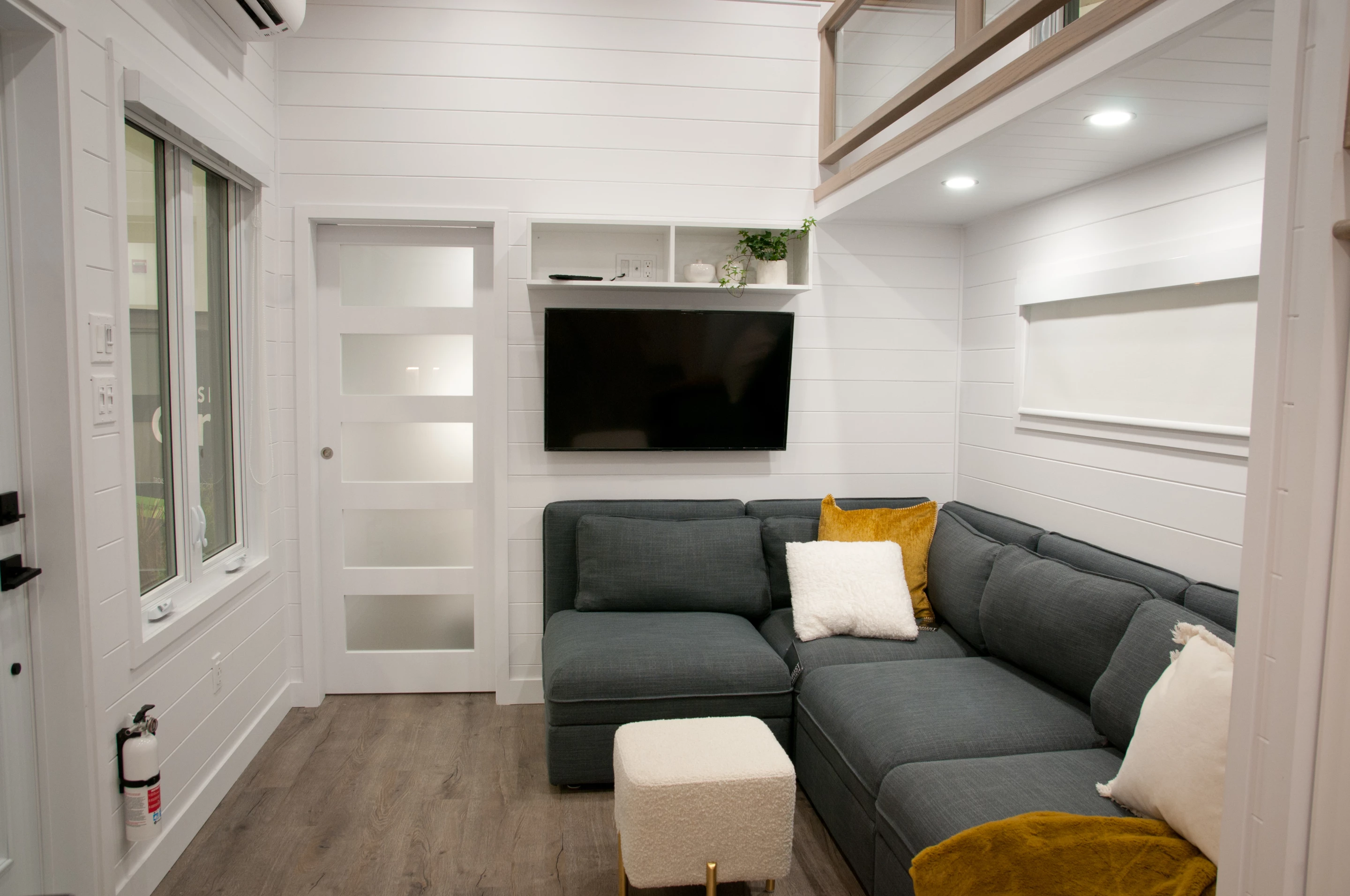 The Charme's living room, which also doubles as the dining area, includes a large storage-integrated sofa that can be rearranged