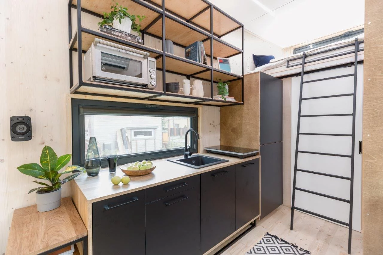 The Dark Vader's kitchen has lots of shelving and cabinetry for a tiny house of its size