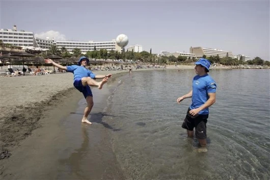 Subaru's Atkinson and Solberg relax on the beach before the event