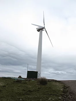 A 100-kW turbine nearby generates enough power for 25 homes, and most of the energy produced is put into the grid (Photo: Mark Waghorn Architects)