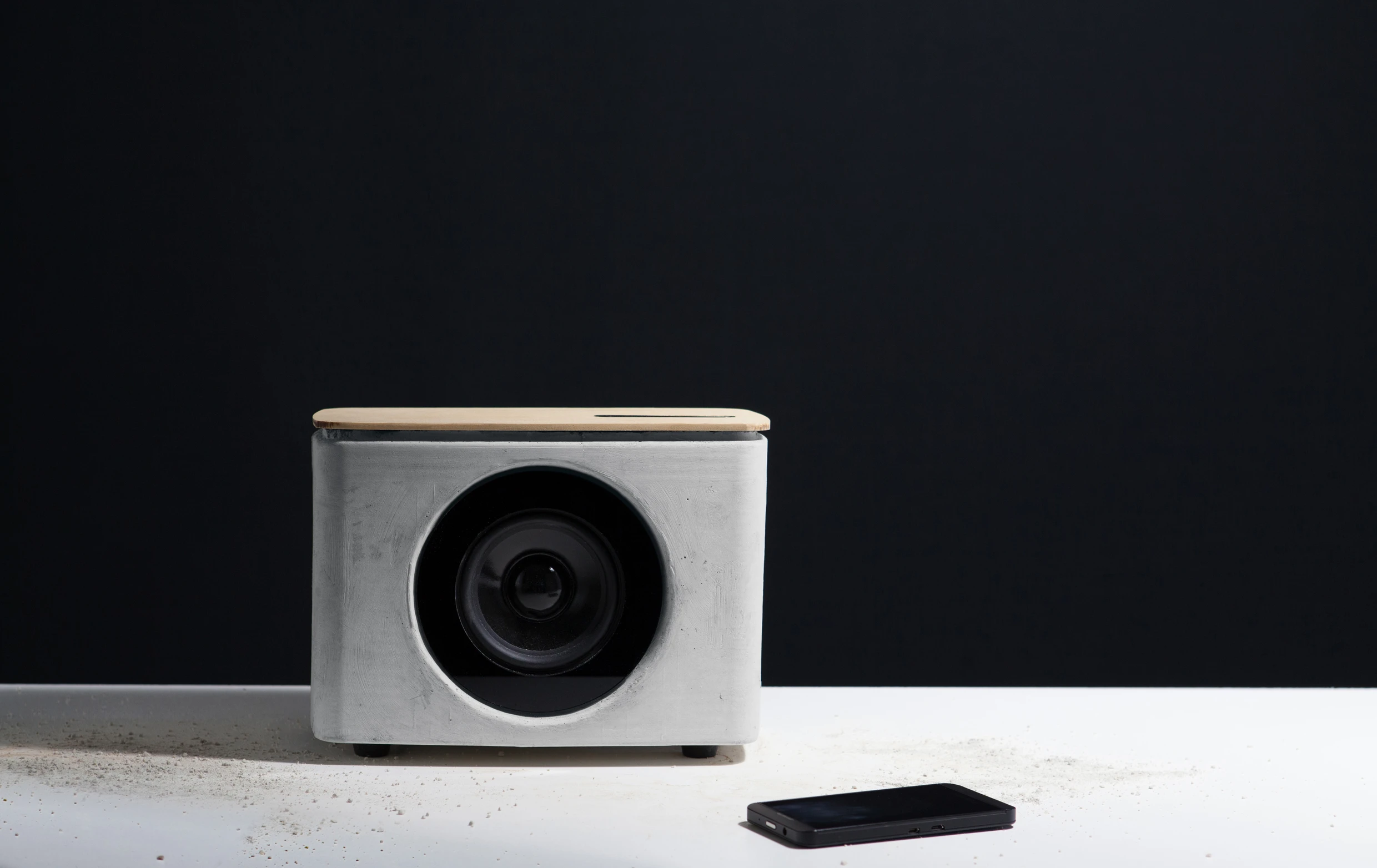 The PACO concrete speaker features two 6 W amps, a front-firing 3.5-inch low/mid range speaker, and a 2-inch surface transducer mounted underneath the fir top