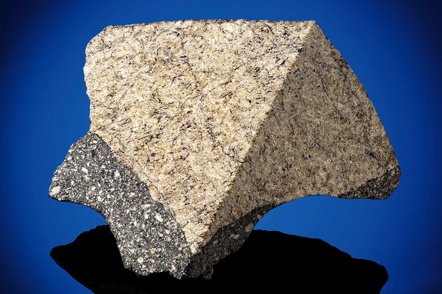 This small sample of lunar meteorite measures just 1 x 1 x 1⅓ inches (25 x 29 x 34 mm) and weighs just 26.2 grams. The parent North West Africa (NWA) 11616 was discovered in 2017. As described by the foremost classifier of lunar meteorites, Dr. Anthony Irving at the University of Washington, this is a polymict fragmental breccia with separate olivine gabbro and rare olivine-free basaltic (lunar mare) clasts in a fragmental matrix. Dr. Irving and lunar geochemist Dr. Randy Korotev completed their analysis of this highly exotic Moon rock in January 2018.
