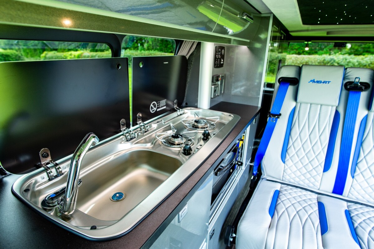 Sink, cooktop and venting window inside the Ford Transit motorhome