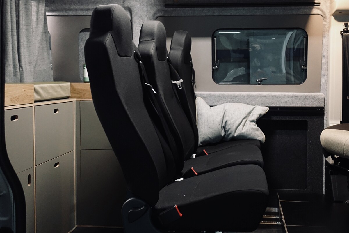 With no kitchen block taking up space against a sidewall, Rocket Camper fits three individual removable seats across