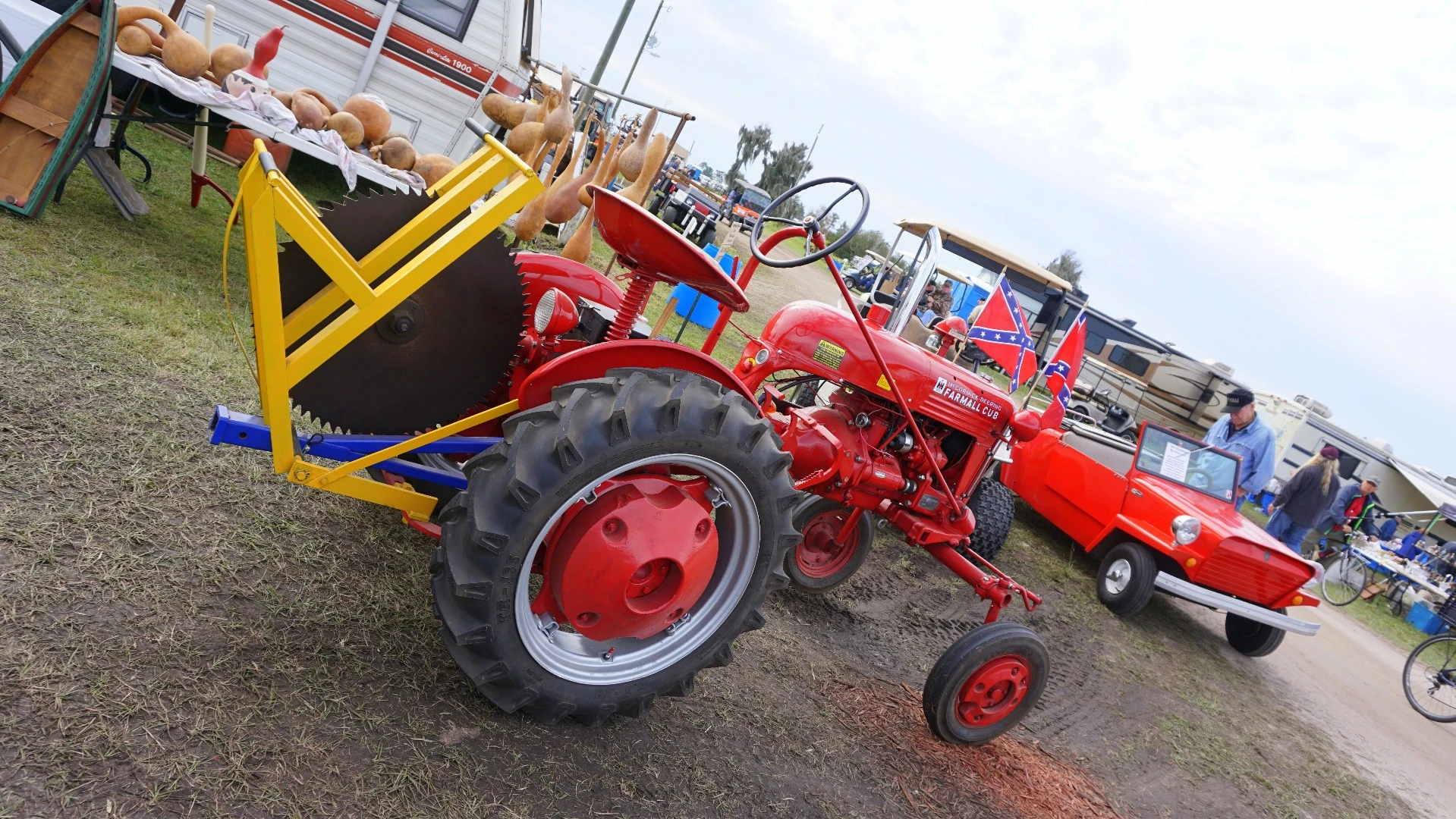 This 1948 Farmall Cub was being driven around as transportation by its owner. The car in the background is a 1962 King Midget. It's owner is proud to tell you he has driven it in 48 states, plus Canada and Mexico, including over the Continental Divide in Colorado and Montana