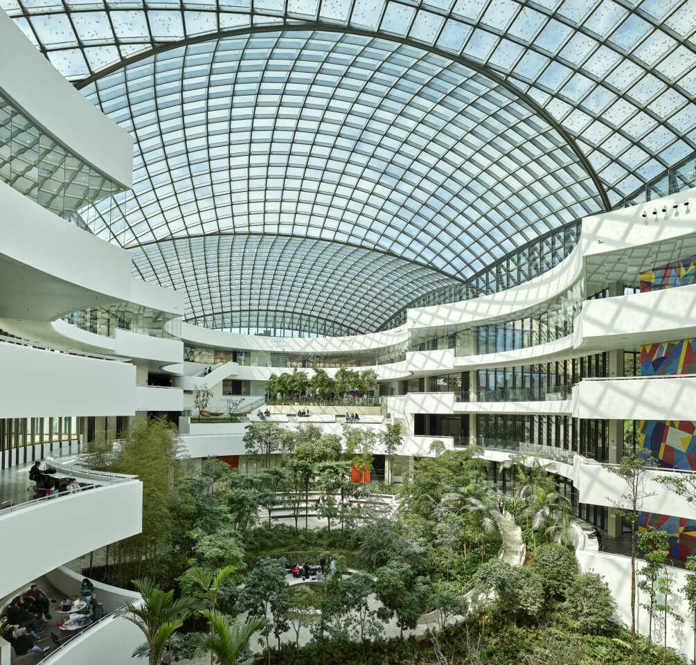 The Albert Einstein Education and Research Center's glass roof encloses a lush green atrium space
