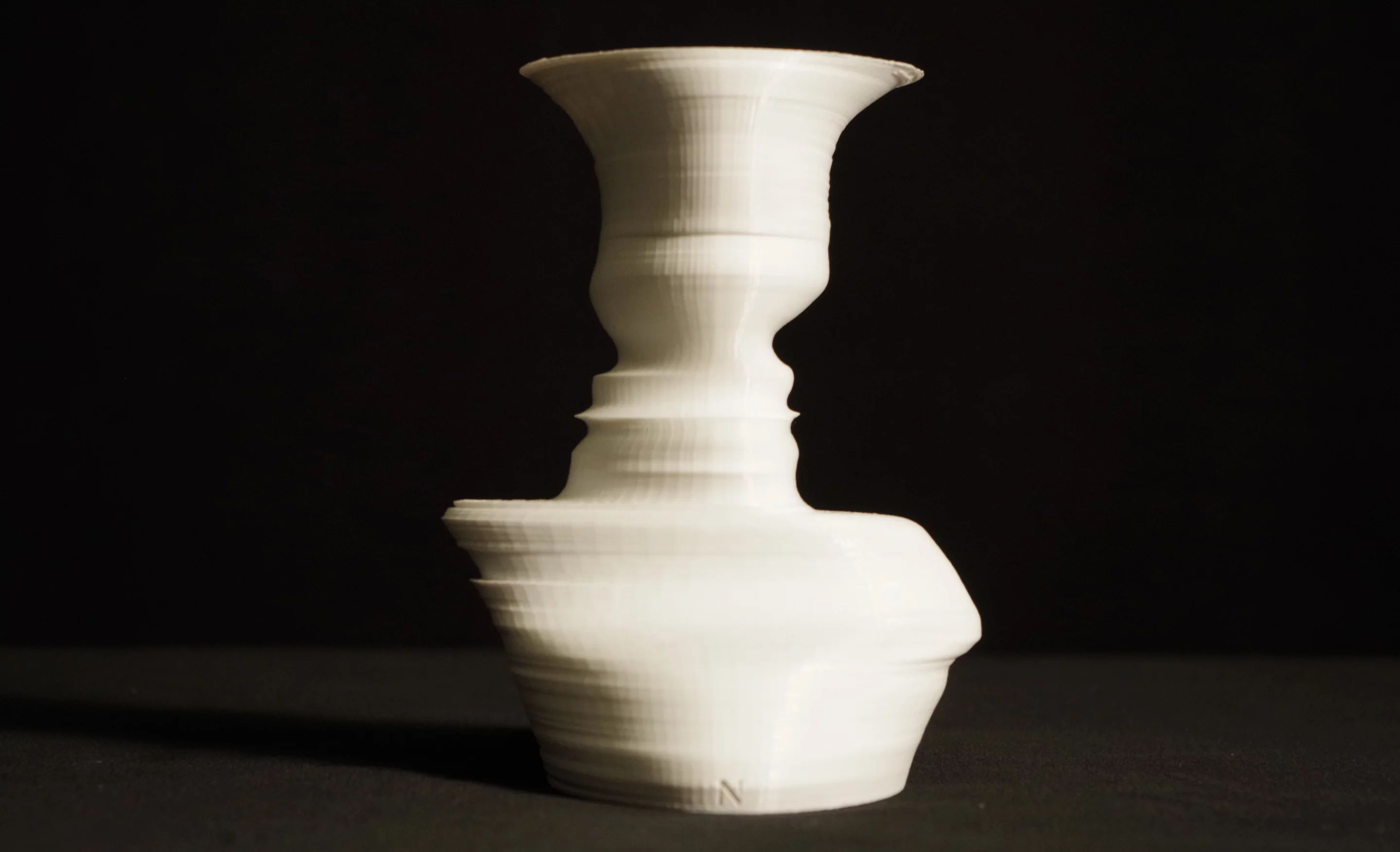 Can't see the faces in this photo? Check out the shape of the black background where it meets either side of the vase