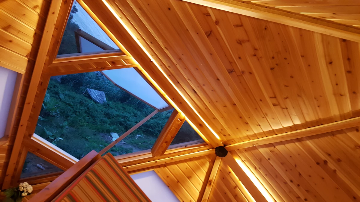 The materials used to build the EcoPods include locally-sourced pumice stone, local timber, and windows made from recycled plastic bottles