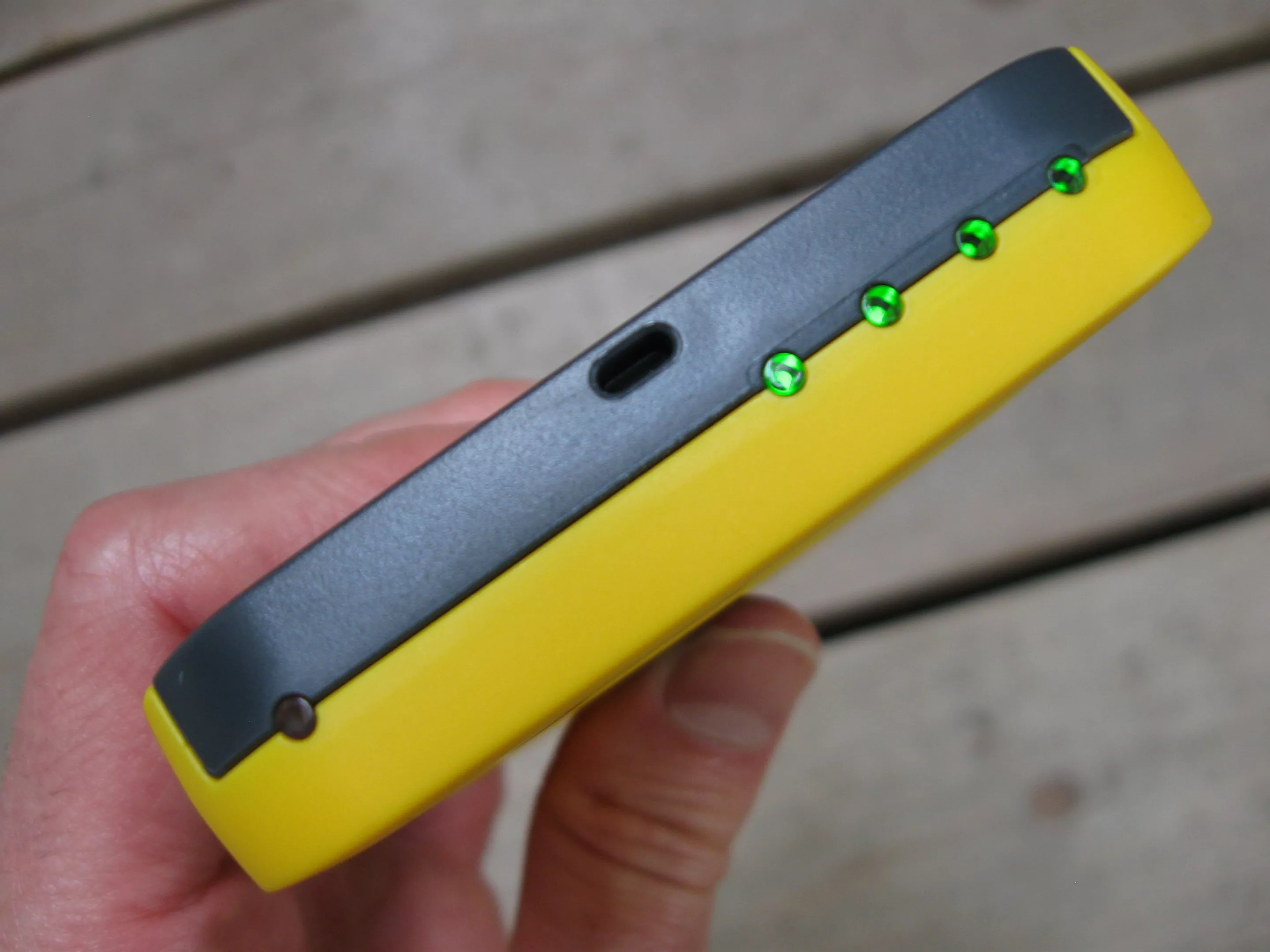 The Waka Waka Power's solar charging indicator light (left) and battery status indicator lights (right)