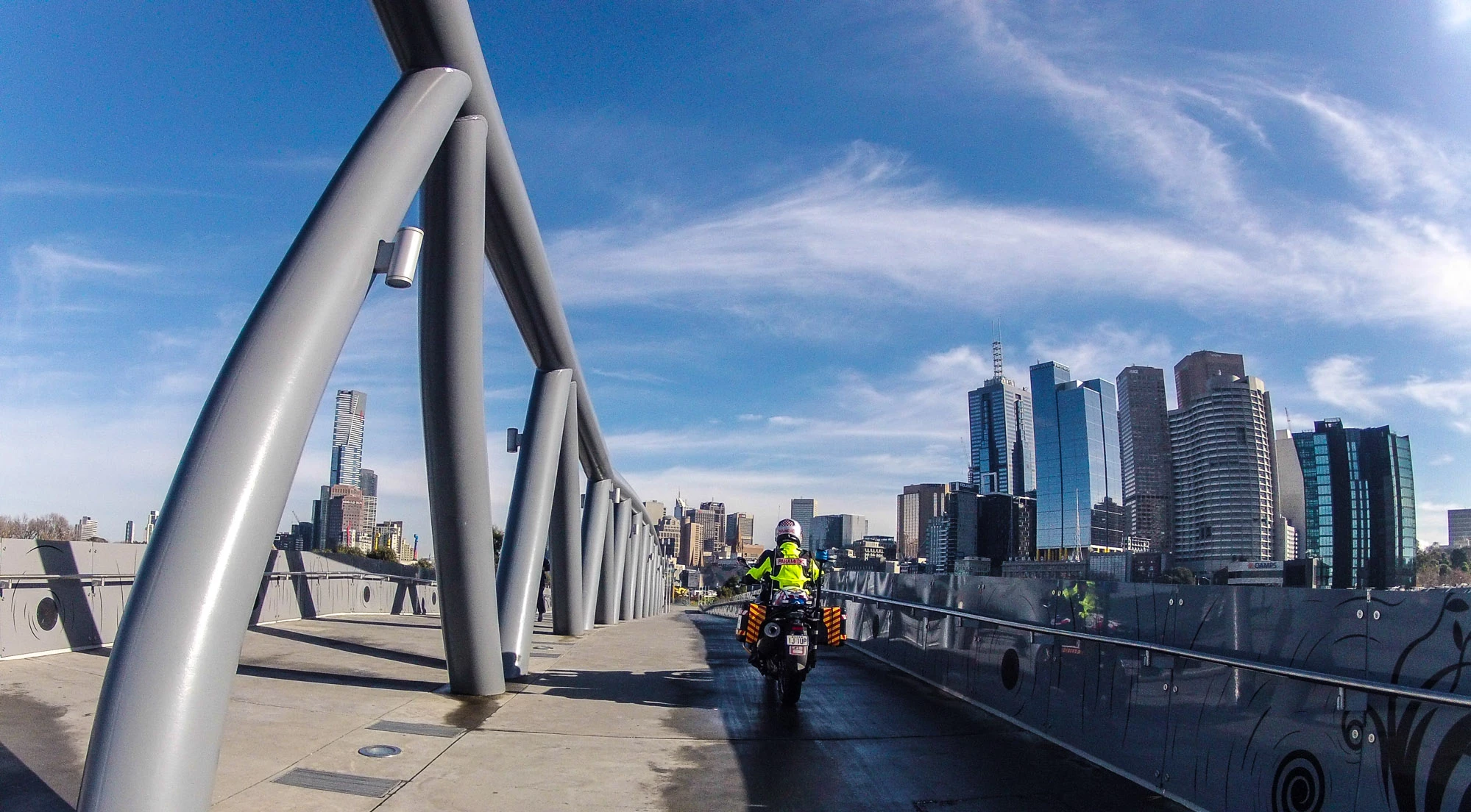 "Beautiful day, look at those clouds! Why am I riding in the shadows? At least my head is warm. Just cruising down the William Barak bridge toward the city, heading for Federation Square. "