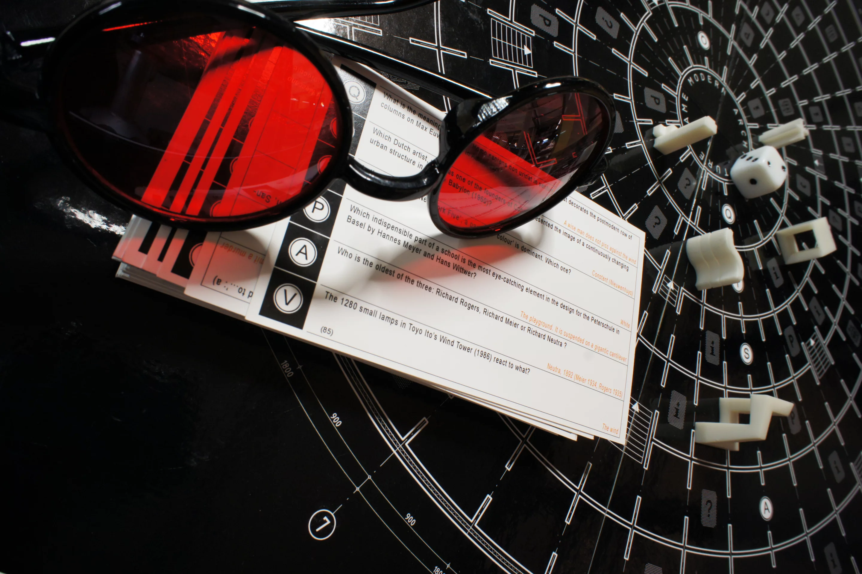 The player in the hot seat dons Le Corbusier's unmistakable eye glasses for the round