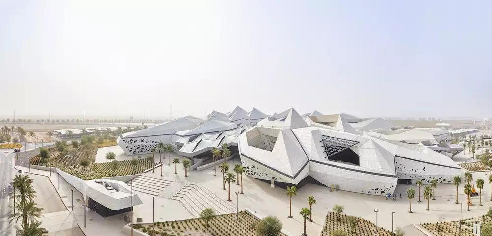 KAPSARC's buildings are interconnected, with shared public spaces, and take the form of hexagonal prismatic honeycomb structures arranged around a large public courtyard shaded by canopies