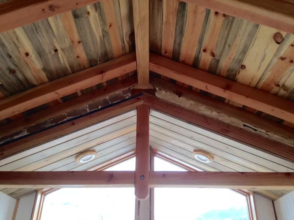The tiny house sports cedar siding and beetle kill pine throughout the interior
