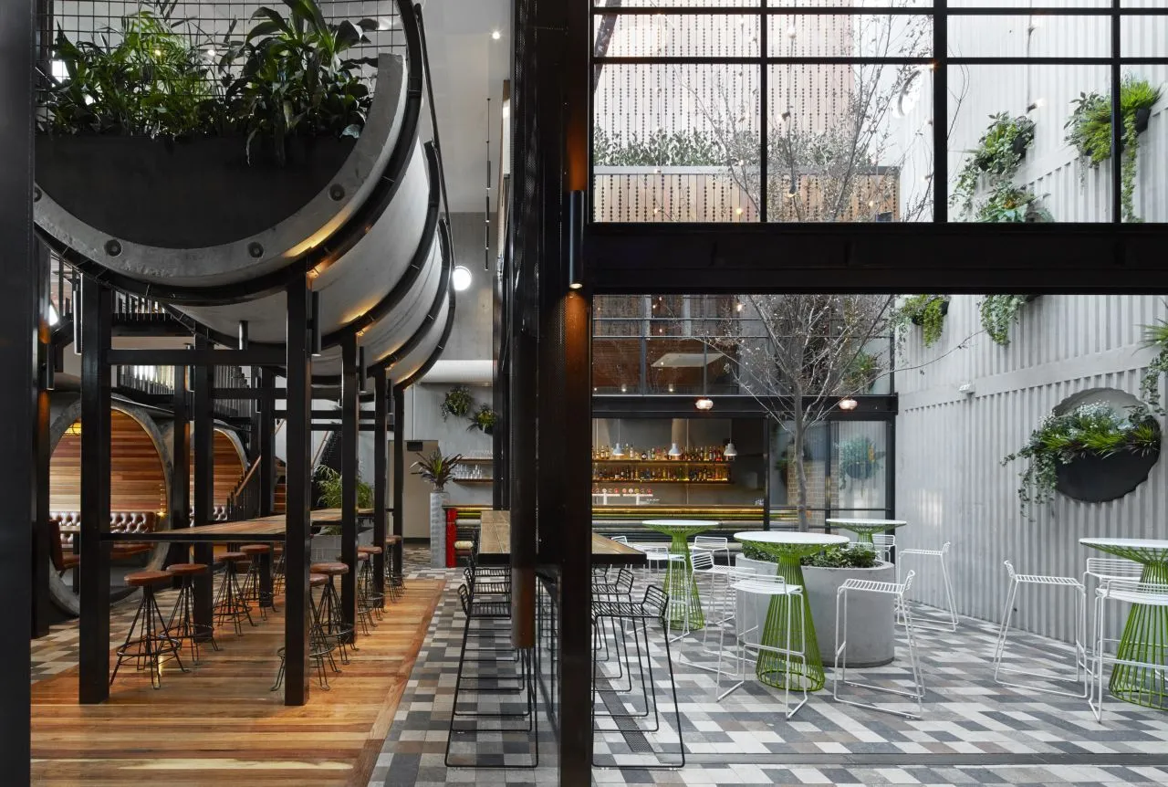 The pub’s interior features an open steel glazed courtyard with hovering half-pipe garden beds