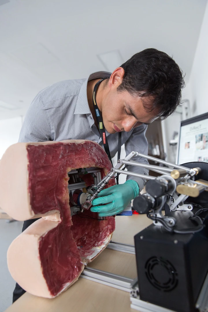 The user slips their finger into a silicone thimble, which is attached to small robotic arms that apply pressure to simulate the feel of healthy or potentially cancerous prostate glands
