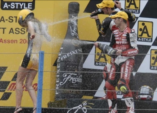The 125 cc Grand Prix podium champagne spraying ceremony entered into the spirit of the sponsorship